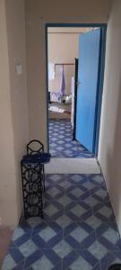a hallway with a room with a blue door at Lk home in Nanyuki