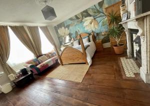 a living room with a bed and a fireplace at The Mansion House Hotel in Holbeach