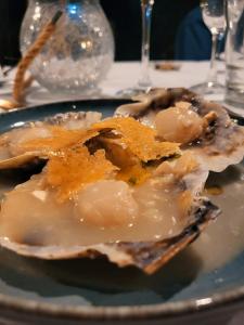 a oyster on a blue plate on a table at Casa Vidal Guesthouse in Tupungato