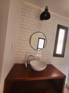 a bathroom with a sink and a mirror at Casa Vidal Guesthouse in Tupungato