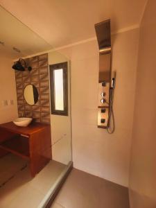 a bathroom with a sink and a mirror at Casa Vidal Guesthouse in Tupungato