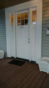 a white front door of a house with a porch at Piano Room Studio with full kitchen and no fees in Florence