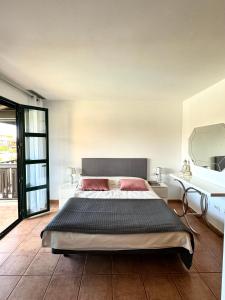 a bedroom with a large bed and a mirror at San Blas Golf del Sur Residence in San Miguel de Abona