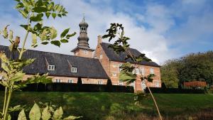 a large brick building with a clock tower on top at Sleeptide in Husum