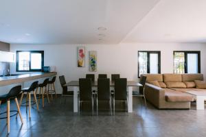 a living room with a couch and a table and chairs at Villa Torres is a great villa only a 10 minute walk from the centre of Playa den Bossa in Ibiza Town