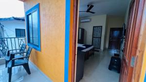 a room with a colorful wall and a balcony at HARSH ANGEL HOLIDAY HOMES in Calangute