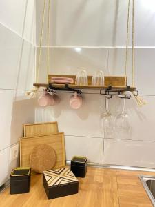 a kitchen with a shelf with wine glasses on it at Casa Saboa in San Bartolomé