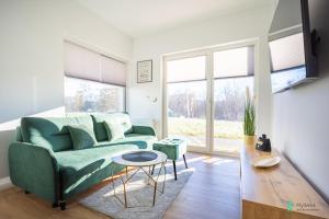 TV a/nebo společenská místnost v ubytování Apartamenty Słoneczna Polana, MyWeek