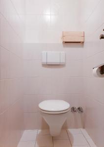 a white bathroom with a toilet and a sink at Alpenflair Innsbruck - mit Parkplatz in Innsbruck