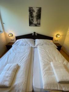 a bed with two pillows on it in a bedroom at International House Sölden Apartment mit 2 Schlafzimmern ZW 7 in Sölden