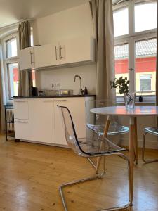 a kitchen with a table and chairs in a room at Studio im Zentrum von Lochau, #1 in Lochau