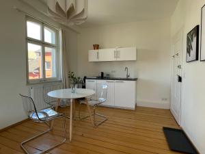 a kitchen with a table and chairs in a room at Studio im Zentrum von Lochau, #4 in Lochau