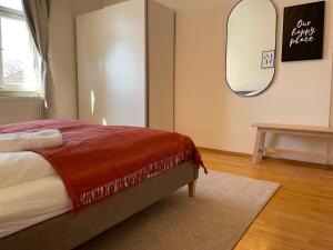 Studio im Zentrum von Lochau, #4 في لوشاو: غرفة نوم مع سرير ومرآة على الحائط