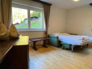 a small room with a bed and a window at International House Sölden Apartment ZW 14 in Sölden