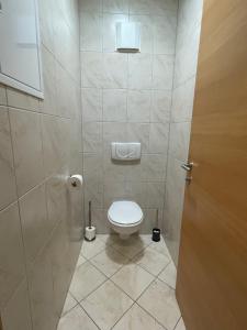a small bathroom with a toilet in a stall at International House Sölden Apartment ZW 14 in Sölden