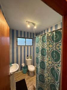 a bathroom with a shower with a toilet and a sink at Casa En Papudo Lomas del Mar in Papudo