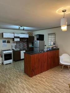 a large kitchen with a counter in a room at Casa En Papudo Lomas del Mar in Papudo