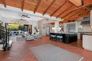 an open kitchen and living room with a living room and dining room at Rooftop Oceanview Patio - 5BR Remodeled Home in Carlsbad