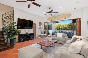 a living room with a couch and a tv at Rooftop Oceanview Patio - 5BR Remodeled Home in Carlsbad