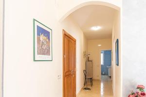 a hallway with a door and a picture on the wall at Bellezza In Cilento Panoramic Apts in Castellabate