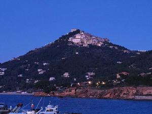 a mountain with a town on top of it at Bellezza In Cilento Panoramic Apts in Castellabate