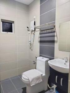 a bathroom with a toilet and a sink at Weng Kong Hotel in Slim River