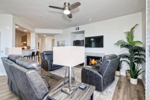 a living room with leather furniture and a fireplace at Lagoon Views - Pool - Hot Tub - Gated Community in Carlsbad