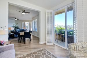 a living room with a table and a dining room at Lagoon Views - Pool - Hot Tub - Gated Community in Carlsbad