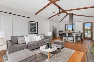 a living room with a couch and a table at Oceanview Rooftop Patio - Walk To The Beach & Park in Carlsbad