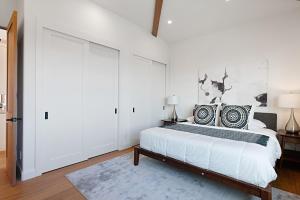 a white bedroom with a bed and a large sliding door at Oceanview Rooftop Patio - Walk To The Beach & Park in Carlsbad