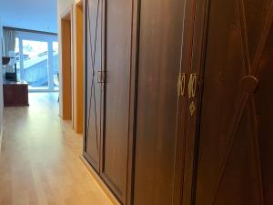 a hallway with two wooden closets in a room at International House Sölden Studio ZW 5 in Sölden