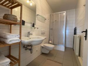 a bathroom with a toilet and a sink and a shower at Studio im Zentrum von Lochau, #5 in Lochau