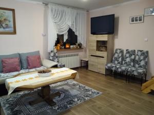 a living room with a couch and a table at Domek Żegary in Sejny