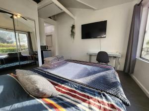 sypialnia z łóżkiem i telewizorem na ścianie w obiekcie Guest Quarters Torrey Pines Golf Ucsd Salk Scripps w mieście San Diego