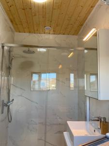 a bathroom with a glass shower and a sink at Casa Saboa in San Bartolomé +23 photos