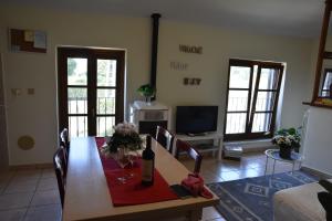 a living room with a table and a television at appartamento vacanze Sofia house in Capannori