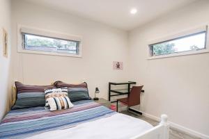 a white bedroom with a bed and two windows at Private Room & Private full Bathroom 3min Walk To UCSD in San Diego
