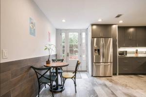 a kitchen with a table and chairs and a refrigerator at Private room shared full bathroom Torrey pines golf UCSD in San Diego