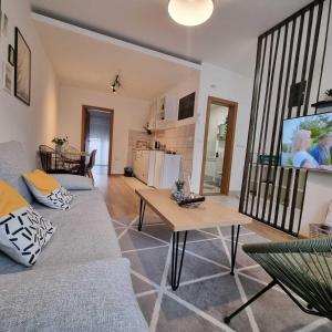 a living room with a couch and a table at Apartment 12-09 in Bajina Bašta