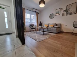 a living room with a couch and a table at Apartment 12-09 in Bajina Bašta