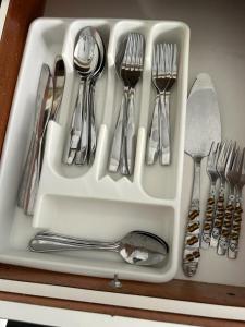a white tray filled with forks and spoons at Casa Centrica 