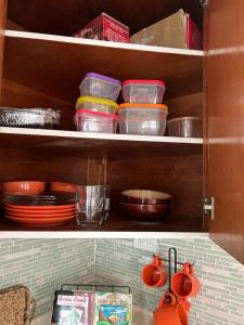 a kitchen cabinet filled with plates and bowls at Casa Centrica 