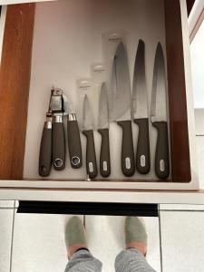 a person is standing in a drawer with knives at Casa Centrica 