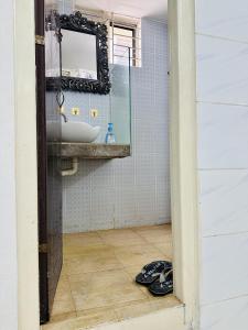 a bathroom with a sink and a mirror at Beautiful 1-Bed Studio in Dhaka in Dhaka