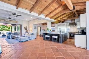 an open kitchen and living room with wooden ceilings at Walk To The Beach - Outdoor Dining - Spacious in Carlsbad