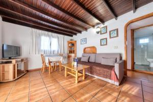 a living room with a couch and a table at Casa Diama in Yaiza