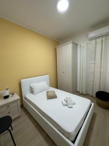a bedroom with a white bed and a white cabinet at The Roman Guesthouse in Rome