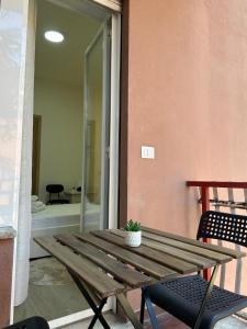 a wooden table with a potted plant on a patio at The Roman Guesthouse in Rome