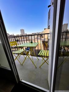 a patio with a table and chairs on a balcony at T2 - L'indispensable in Orléans