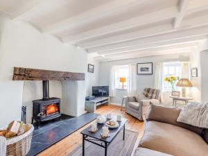 a living room with a fireplace and a couch at 2 Bed in Betws-y-Coed SKN03 in Yspytty-Ifan
